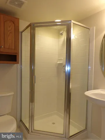 a bathroom that has a glass shower door