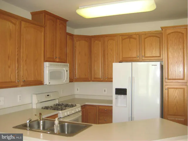 a kitchen with a refrigerator and a stove