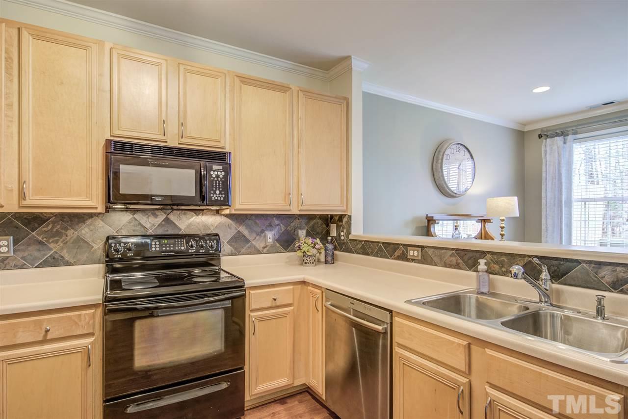 9535 Hanging Rock Road Raleigh, NC 27613 - Photo 11 of 27 a kitchen with stainless steel appliances granite countertop a sink stove and microwave