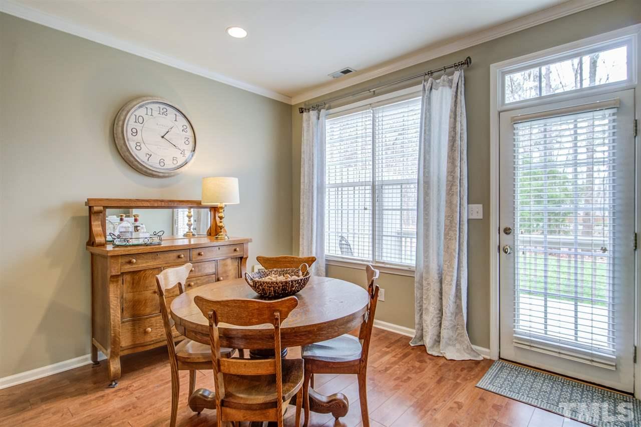 9535 Hanging Rock Road Raleigh, NC 27613 - Photo 12 of 27 a view of a dining room with furniture window and wooden floor