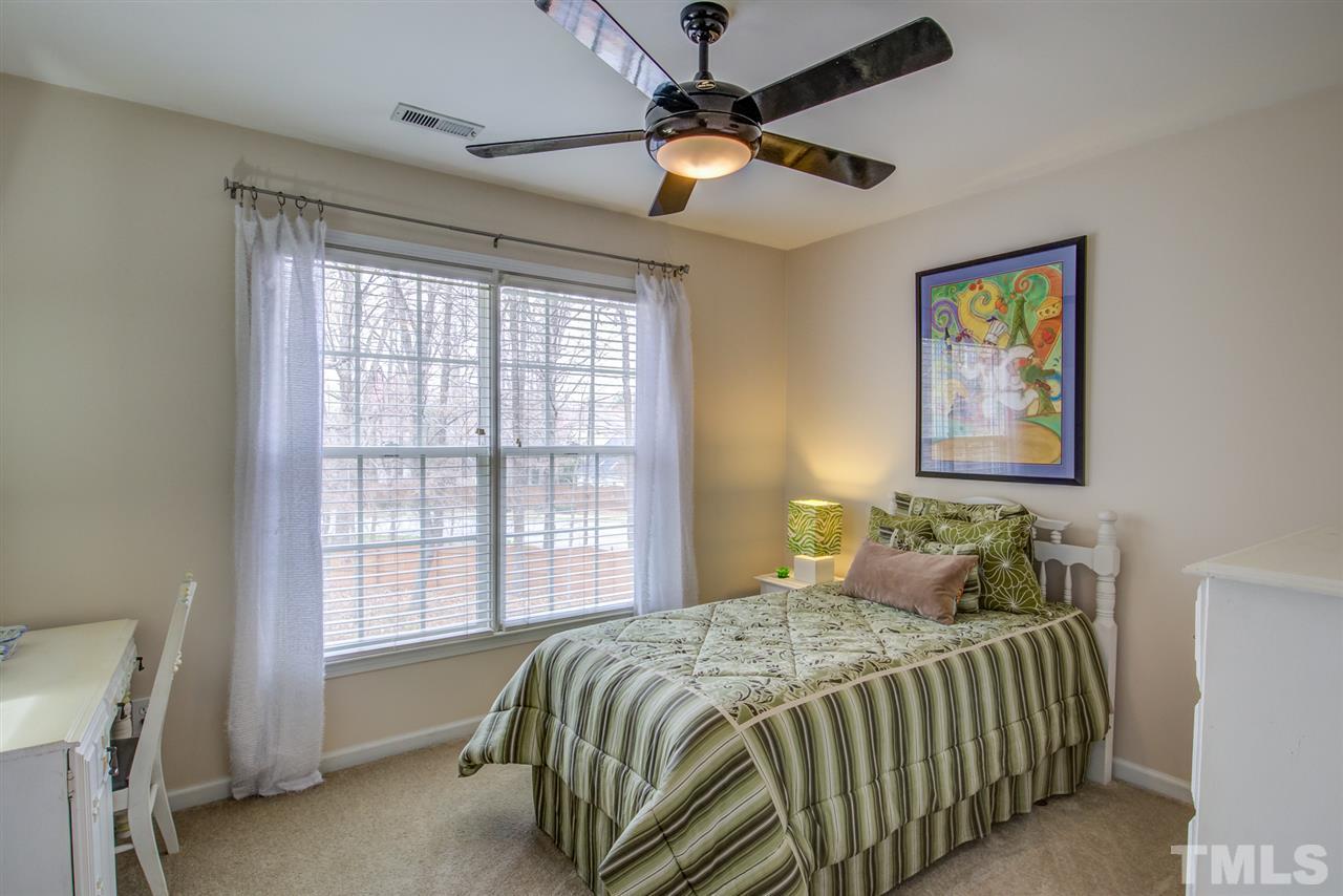 9535 Hanging Rock Road Raleigh, NC 27613 - Photo 15 of 27 a bedroom with a bed and a window