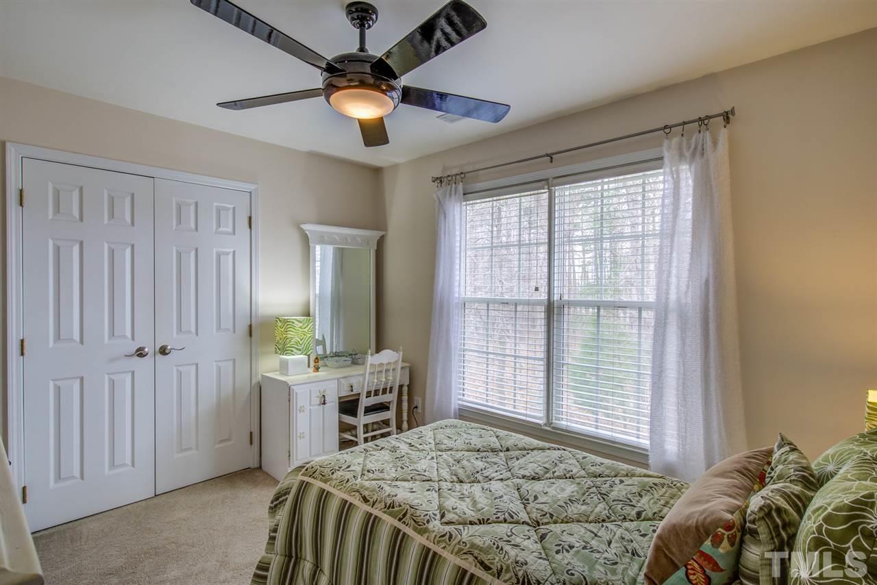9535 Hanging Rock Road Raleigh, NC 27613 - Photo 16 of 27 a bedroom with a bed and a window