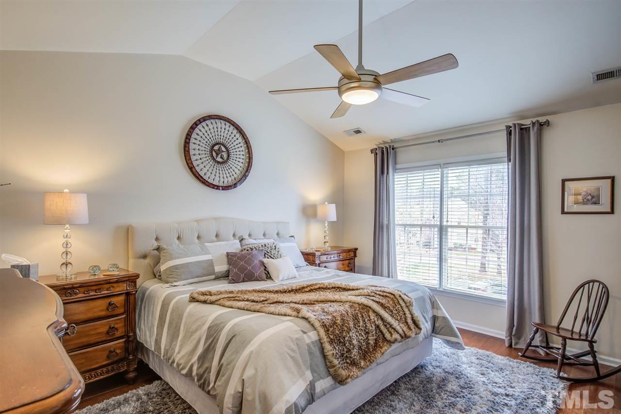 9535 Hanging Rock Road Raleigh, NC 27613 - Photo 20 of 27 a bedroom with a bed and a large window
