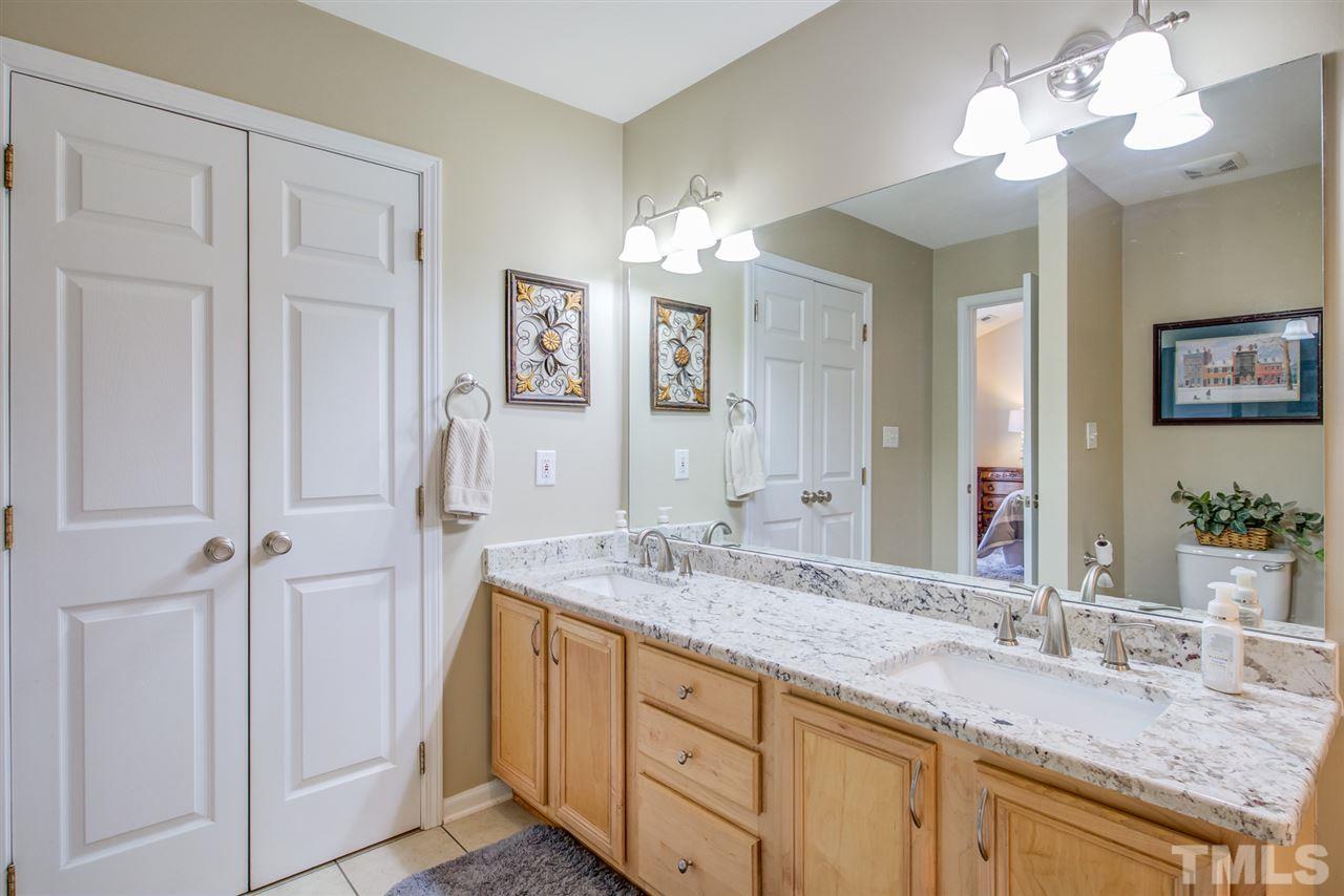 9535 Hanging Rock Road Raleigh, NC 27613 - Photo 22 of 27 a bathroom with a granite countertop double vanity sink and a mirror