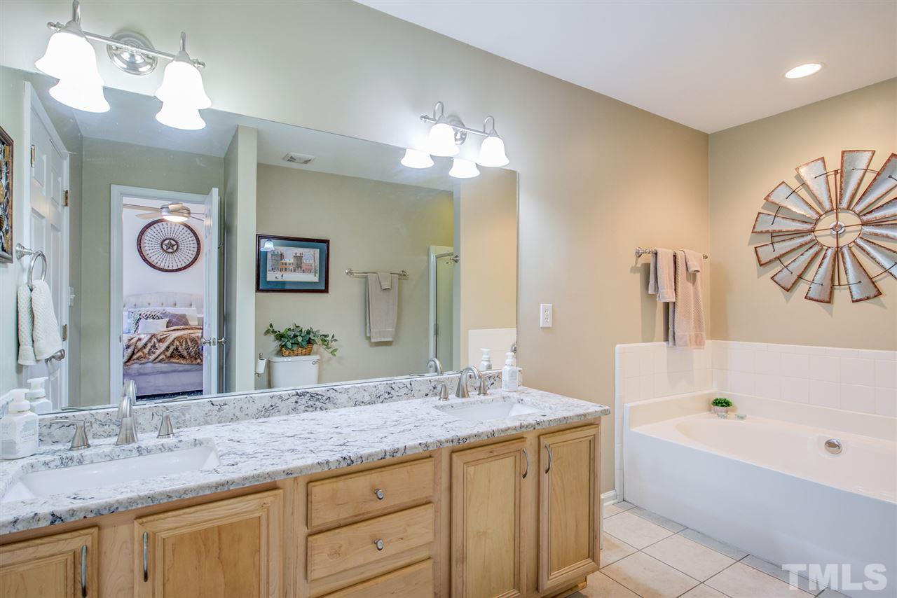 9535 Hanging Rock Road Raleigh, NC 27613 - Photo 24 of 27 a bathroom with a granite countertop sink and a mirror