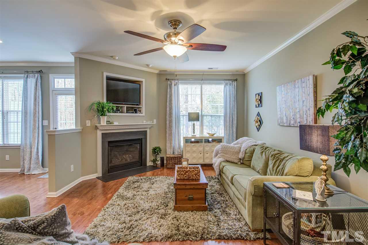 9535 Hanging Rock Road Raleigh, NC 27613 - Photo 4 of 27 a living room with furniture a fireplace and a flat screen tv