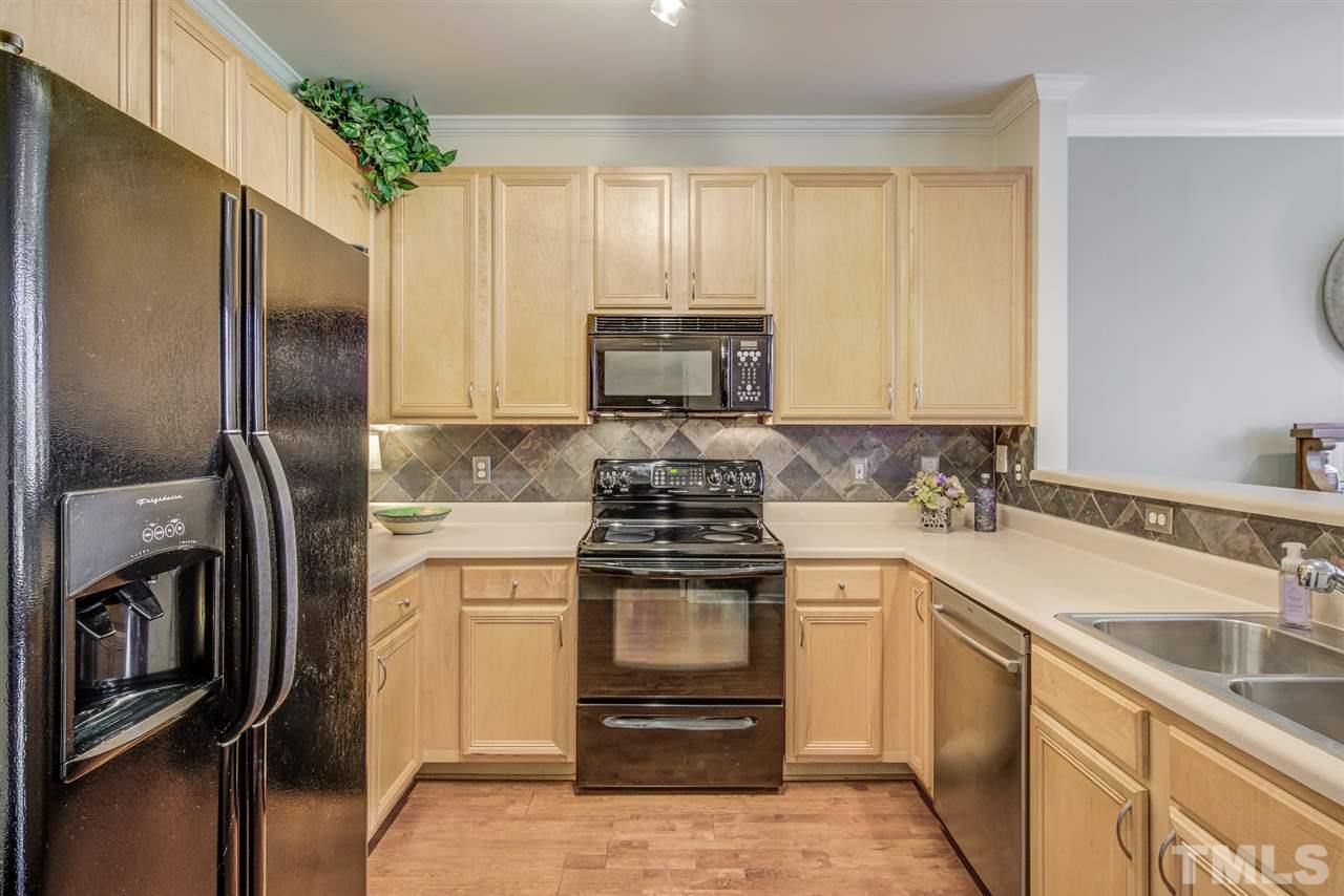 9535 Hanging Rock Road Raleigh, NC 27613 - Photo 8 of 27 a kitchen with a stove sink and refrigerator