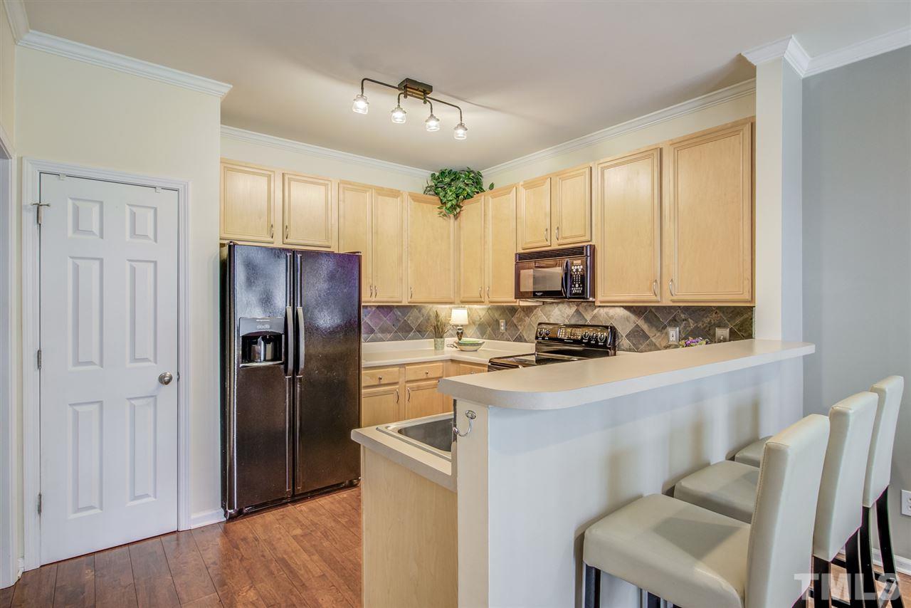 9535 Hanging Rock Road Raleigh, NC 27613 - Photo 9 of 27 a kitchen with cabinets and stainless steel appliances