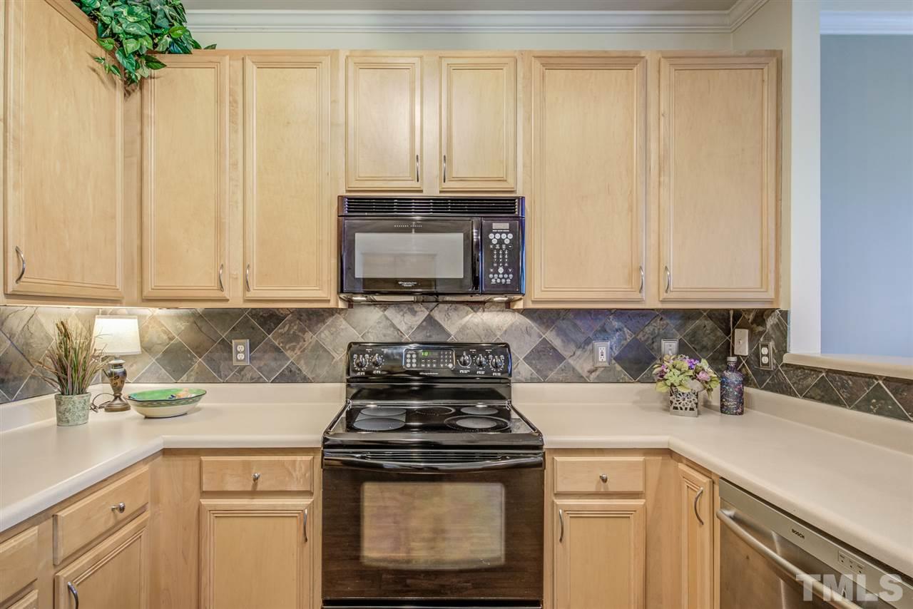 9535 Hanging Rock Road Raleigh, NC 27613 - Photo 10 of 27 a kitchen with granite countertop white cabinets and stainless steel appliances