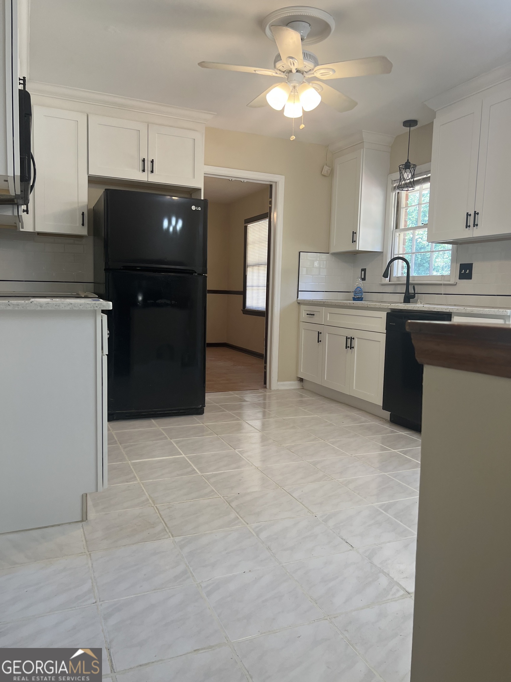 4910 Thompson Mill Road Lithonia, GA 30038 - Photo 13 of 28 a kitchen with a refrigerator and cabinets