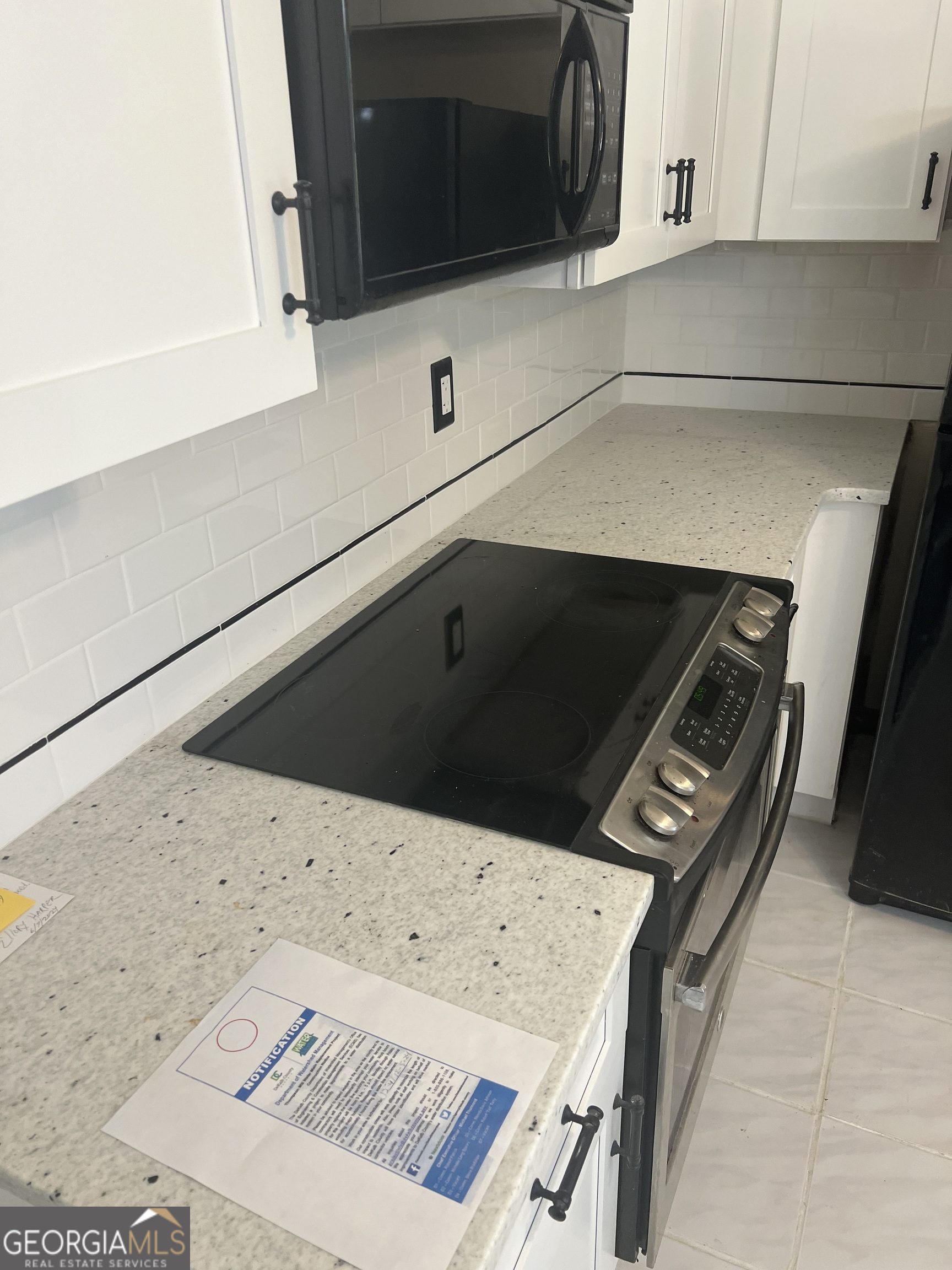 4910 Thompson Mill Road Lithonia, GA 30038 - Photo 14 of 28 a kitchen with a stove and a microwave