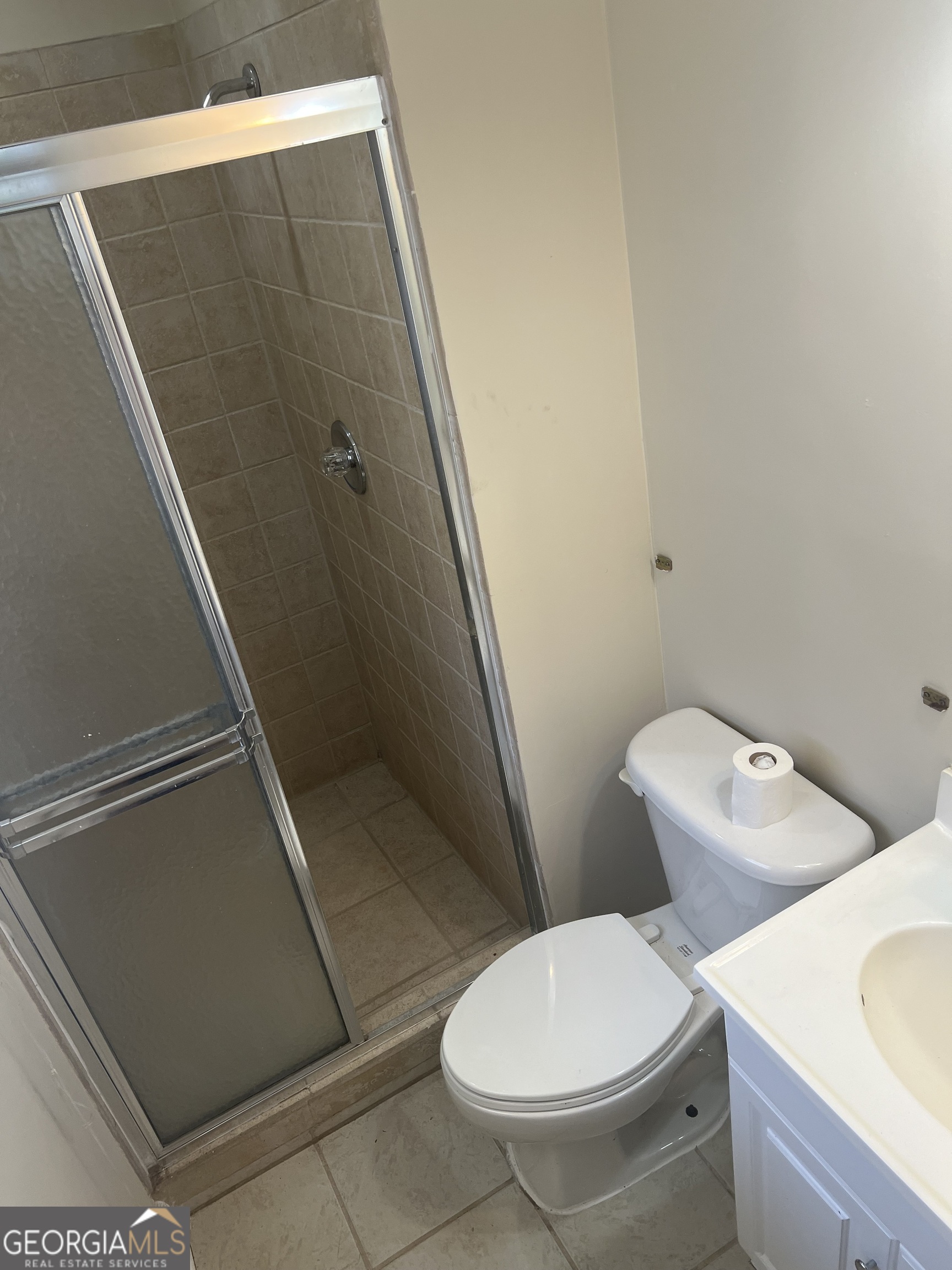 4910 Thompson Mill Road Lithonia, GA 30038 - Photo 19 of 28 a white toilet sitting next to a bath tub