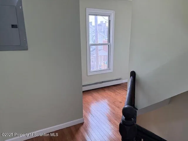 a view of front door with wooden floor