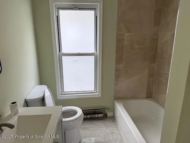 a bathroom with a tub sink and toilet