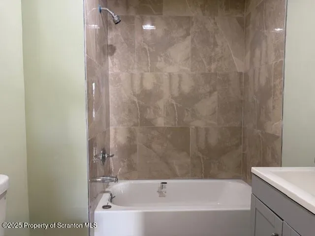 a bathroom with a bathtub and shower