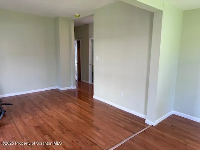 a view of a room with wooden floor and closet