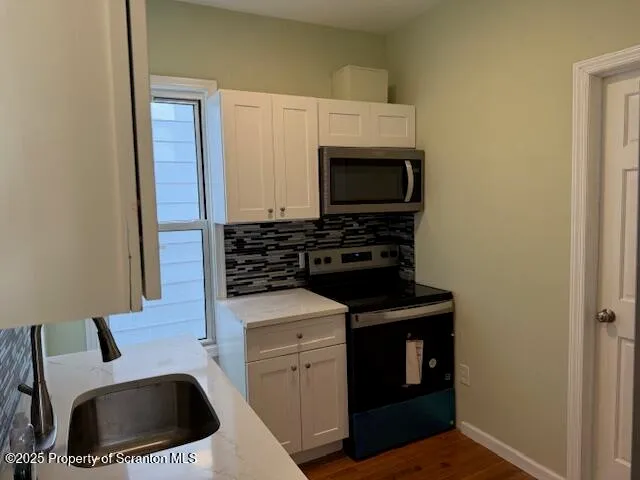 a kitchen with a stove and a microwave