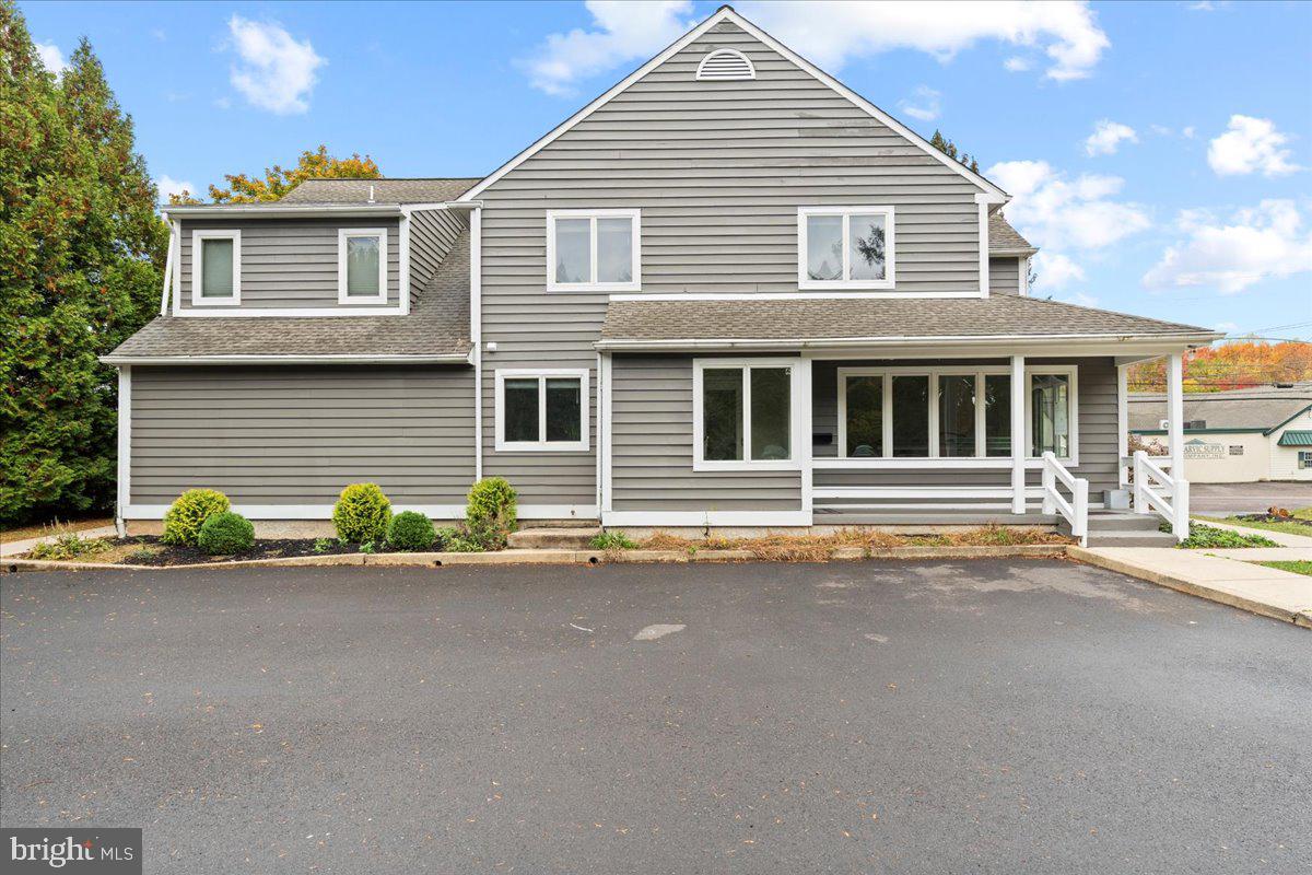 a front view of a house with a road
