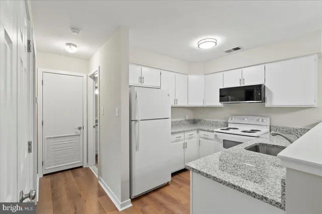 a kitchen with a sink stove and refrigerator