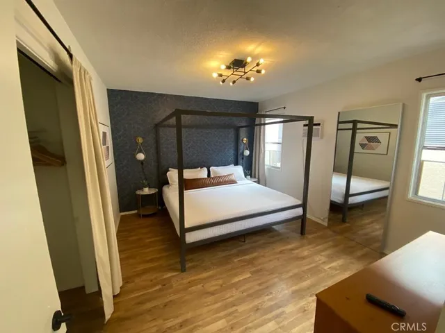 a bedroom with a bed and a mirror