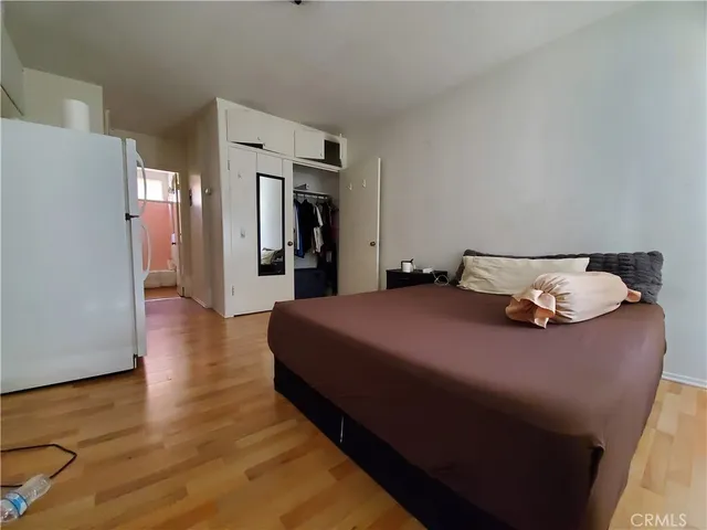 a bed room with a bed and wooden floor