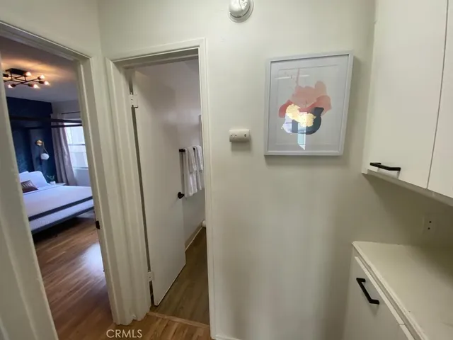 a view of a hallway and a livingroom with furniture