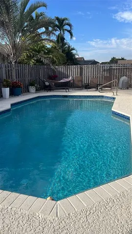 a view of a yard with a wooden fence