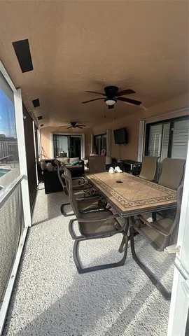a living room with furniture a flat screen tv and a table