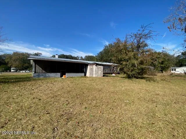 a view of livingroom with workspace and a window