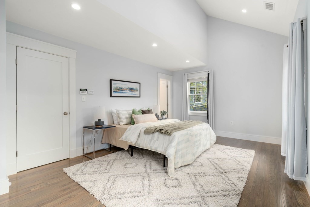 154 Spring Street, Unit 154 Watertown, MA 02472 - Photo 15 of 27 a bed sitting in a spacious bedroom next to a window