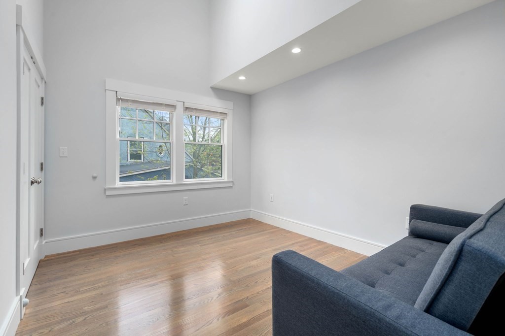 154 Spring Street, Unit 154 Watertown, MA 02472 - Photo 18 of 27 a living room with furniture and a window