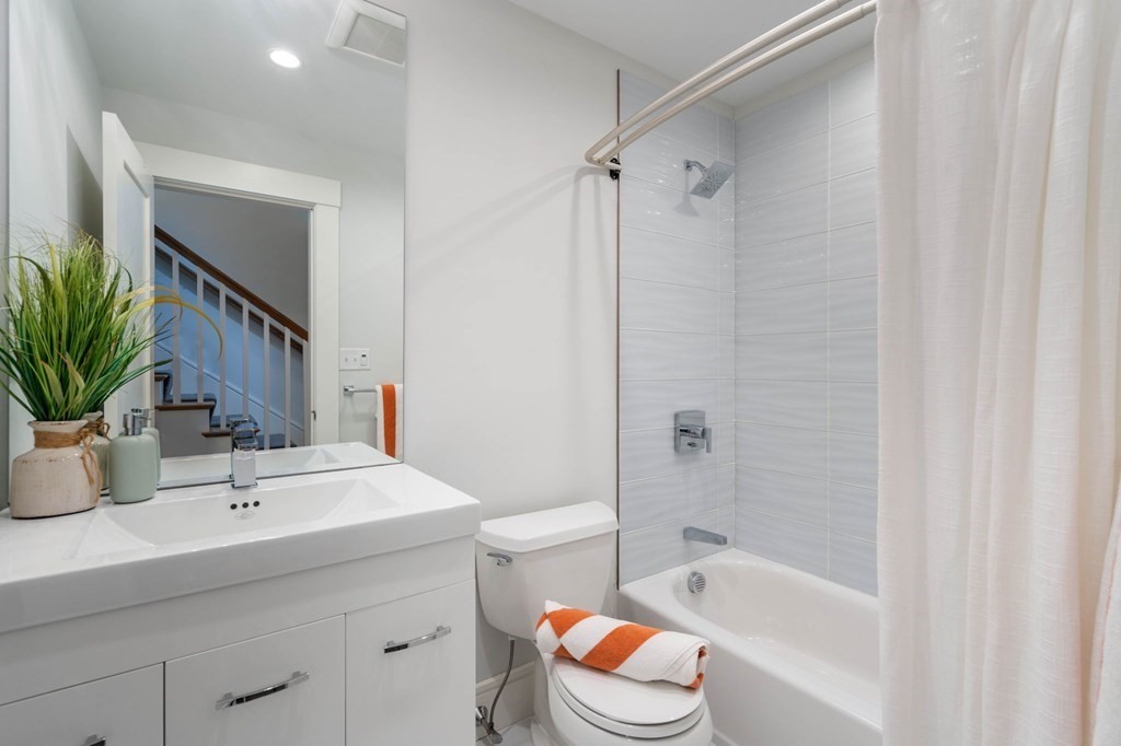 154 Spring Street, Unit 154 Watertown, MA 02472 - Photo 20 of 27 a bathroom with a sink a toilet a tub and shower