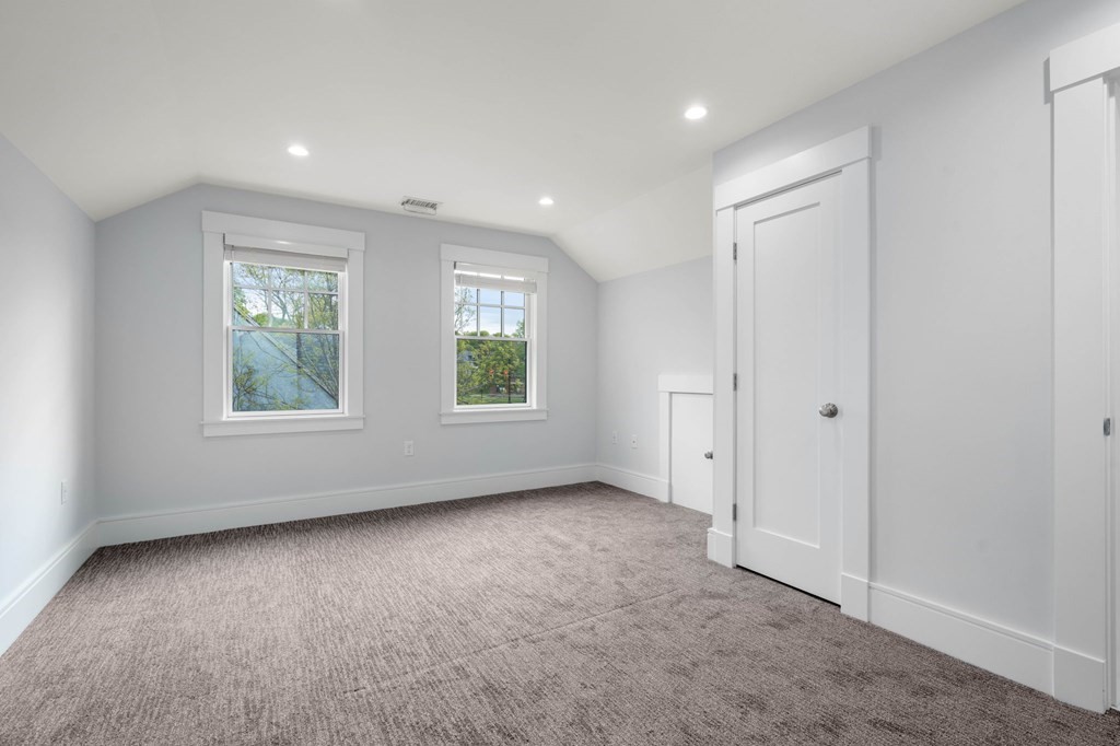 154 Spring Street, Unit 154 Watertown, MA 02472 - Photo 21 of 27 an empty room with windows and closet