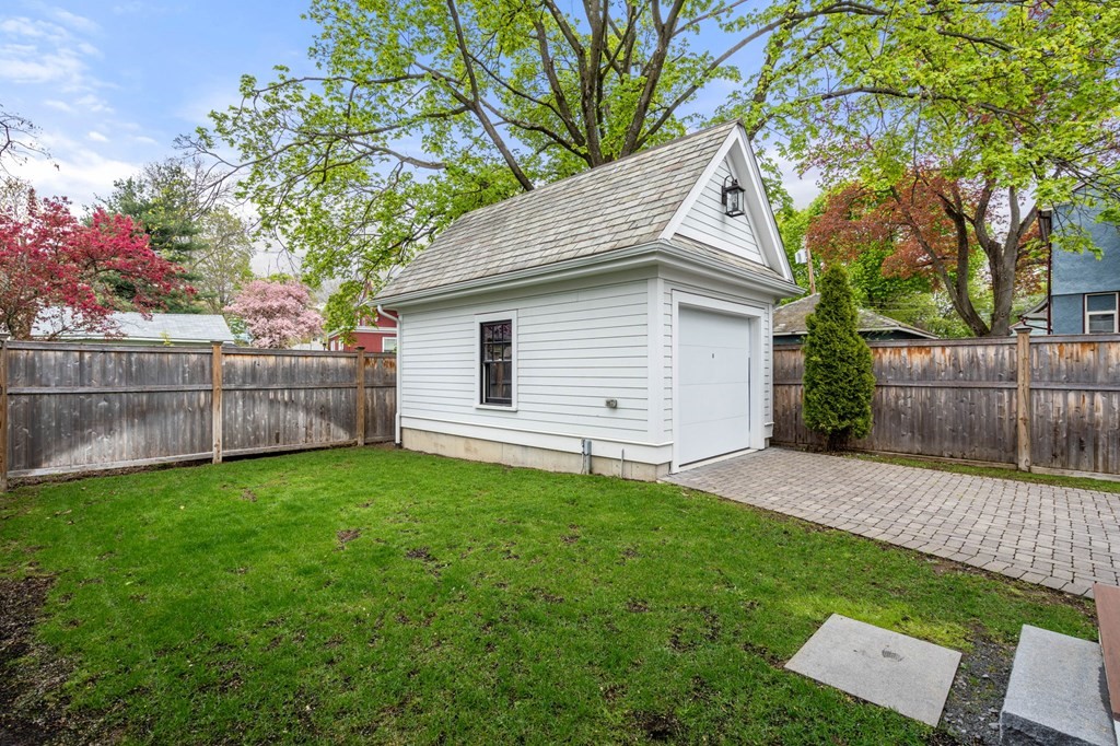 154 Spring Street, Unit 154 Watertown, MA 02472 - Photo 27 of 27 a view of a backyard with a small cabin and wooden fence