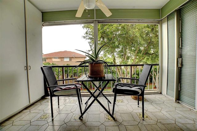 a view of a chairs and table in the balcony