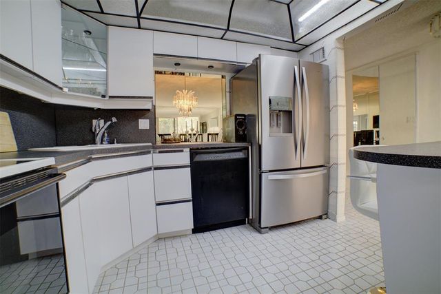a kitchen with stainless steel appliances a refrigerator and a sink