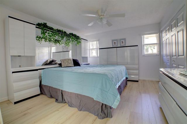 a bedroom with a bed and a large window