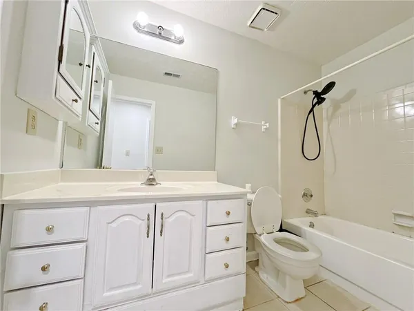 a bathroom with a granite countertop toilet sink and a bathtub