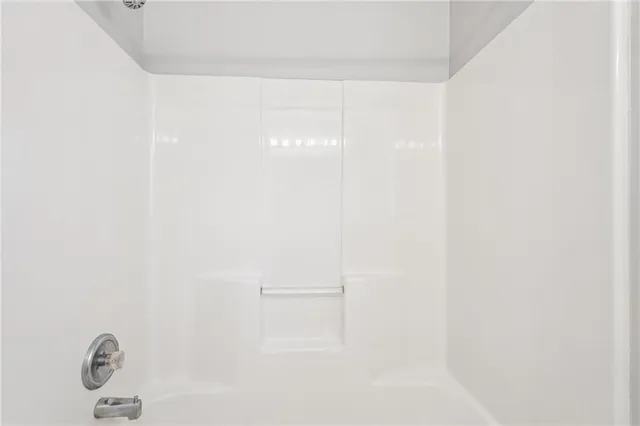 a white bath tub sitting next to a white sink