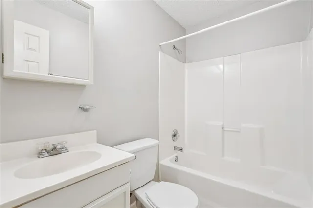 an aerial view of house with yard and mountain view in back