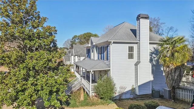 a view of an empty room with a fireplace and a window