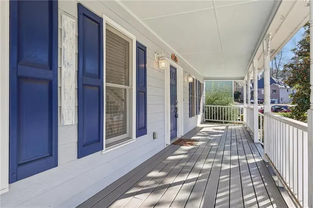 a view of an empty room with a fireplace and a window