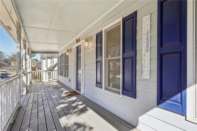 a view of an empty room with a fireplace and a window