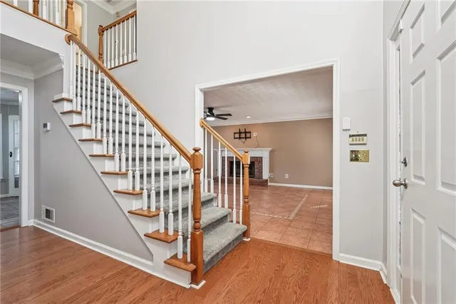 a view of an empty room with a fireplace and a window