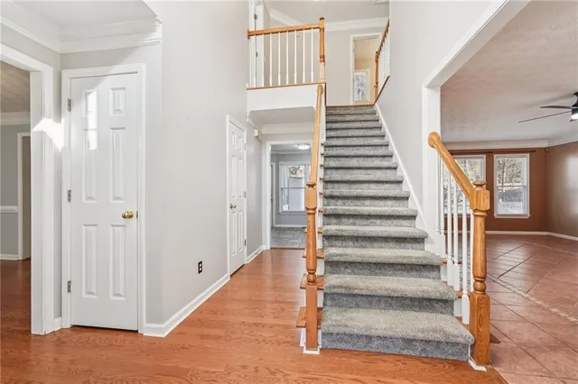 an empty room with windows and fireplace