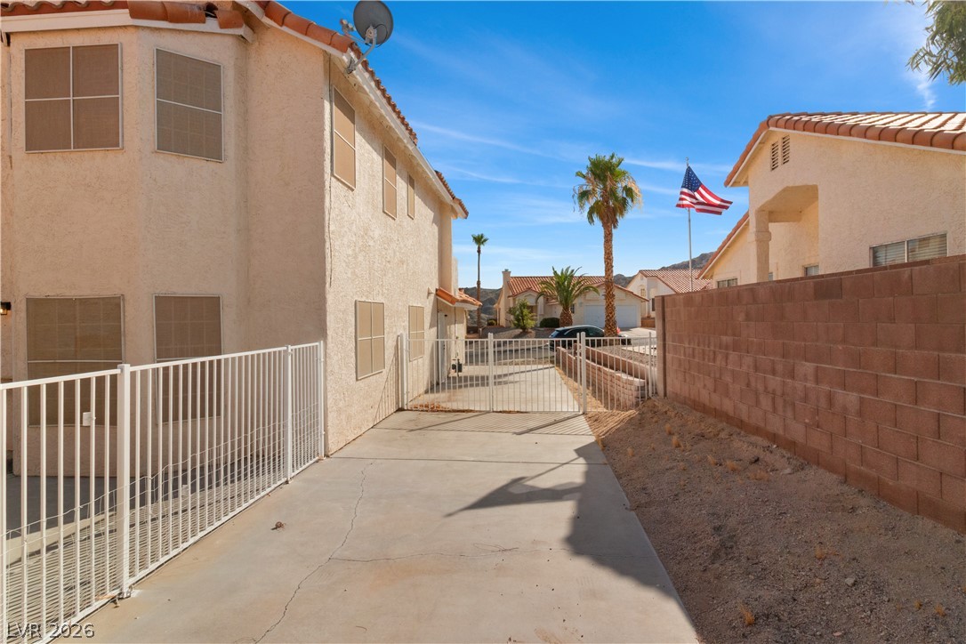 3156 Terrace View Drive Laughlin, NV 89029 - Photo 59 of 94 A private driveway and gate lead to a desert oasis with mature palm trees.