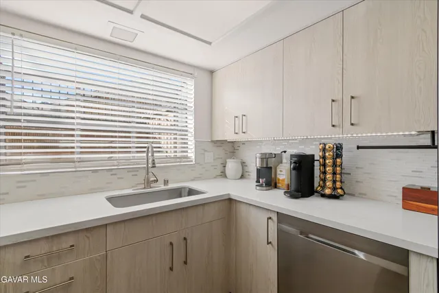 a kitchen with a sink and cabinets