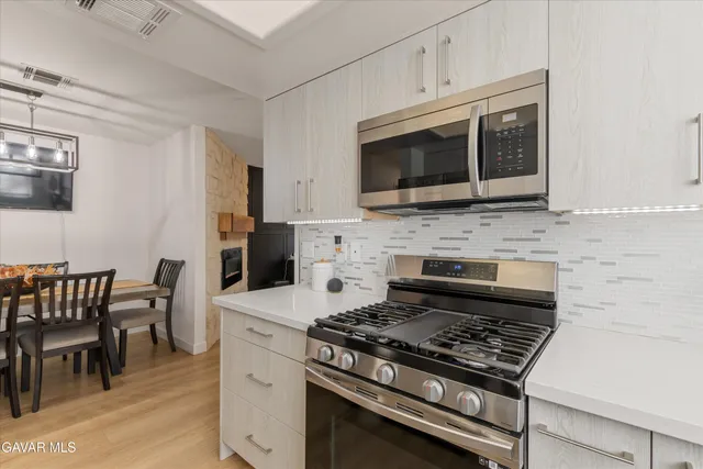 a white stove top oven sitting inside of a kitchen