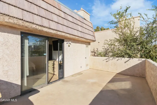 a view of backyard with outdoor seating and green space