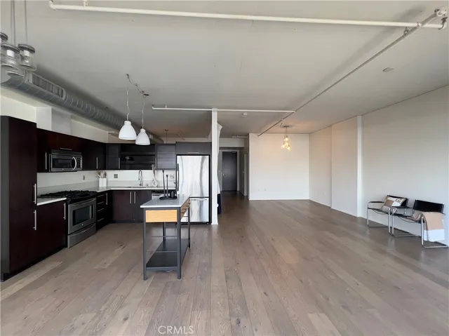 a kitchen with a table chairs refrigerator and cabinets